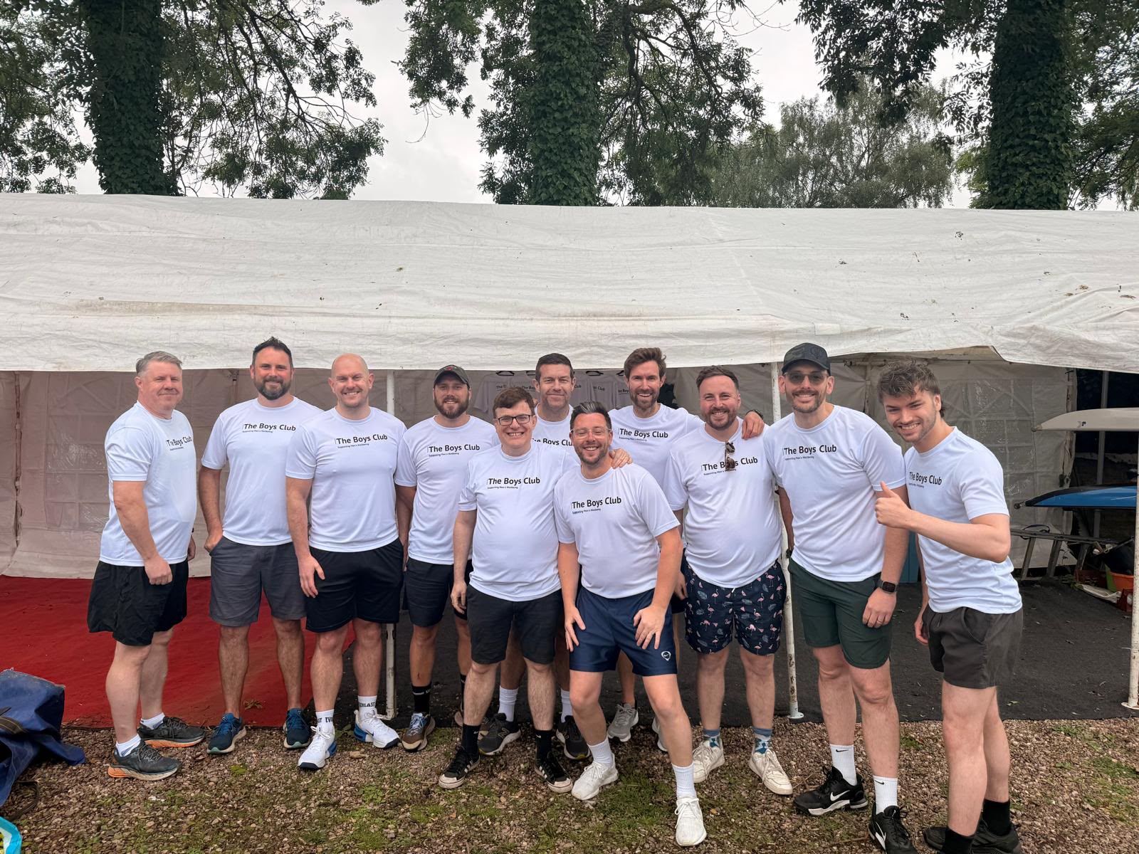 The whole team lined up in their matching The Boys Club t-shirts in front of the marquee