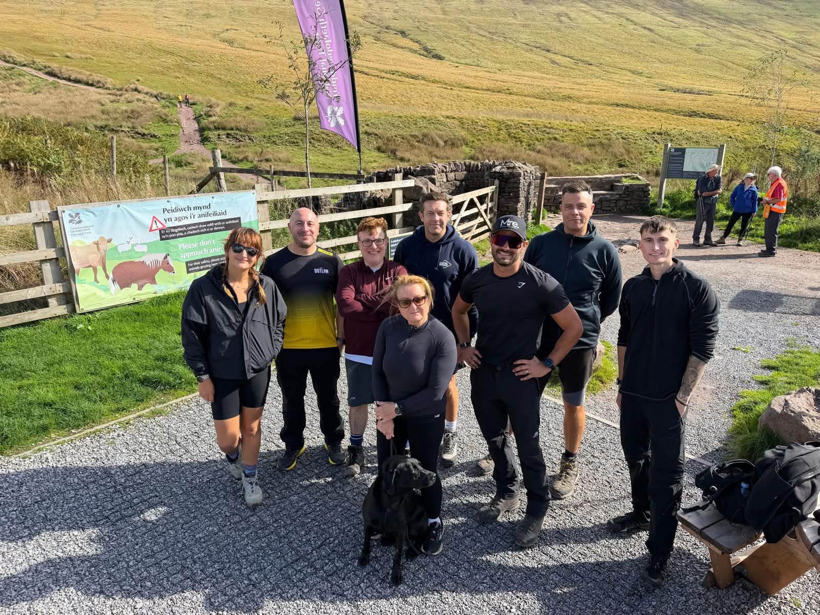 The group gathered at the trailhead gate before setting off up the hill