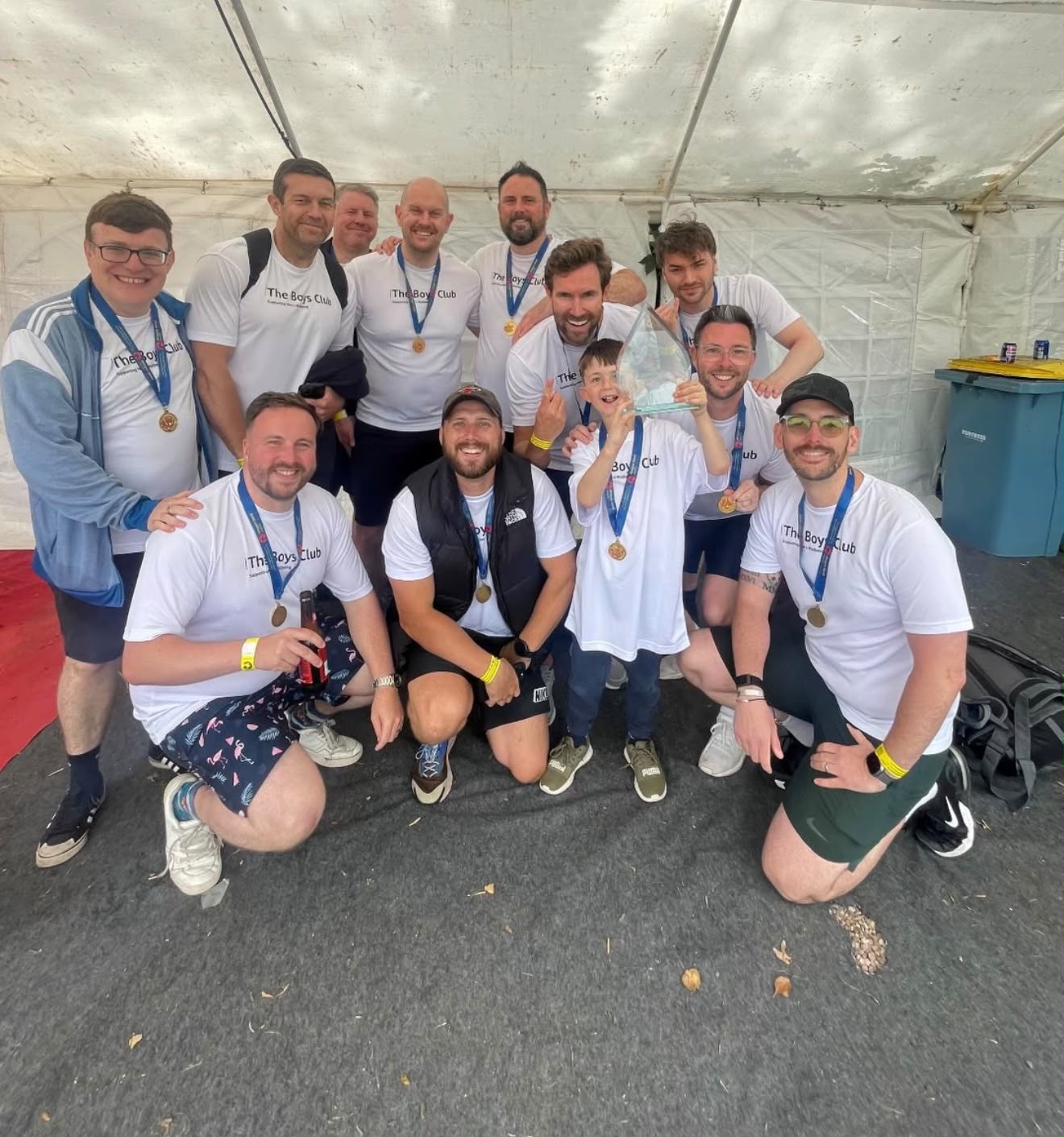 The team together in the marquee after the race, with the trophy and their medals
