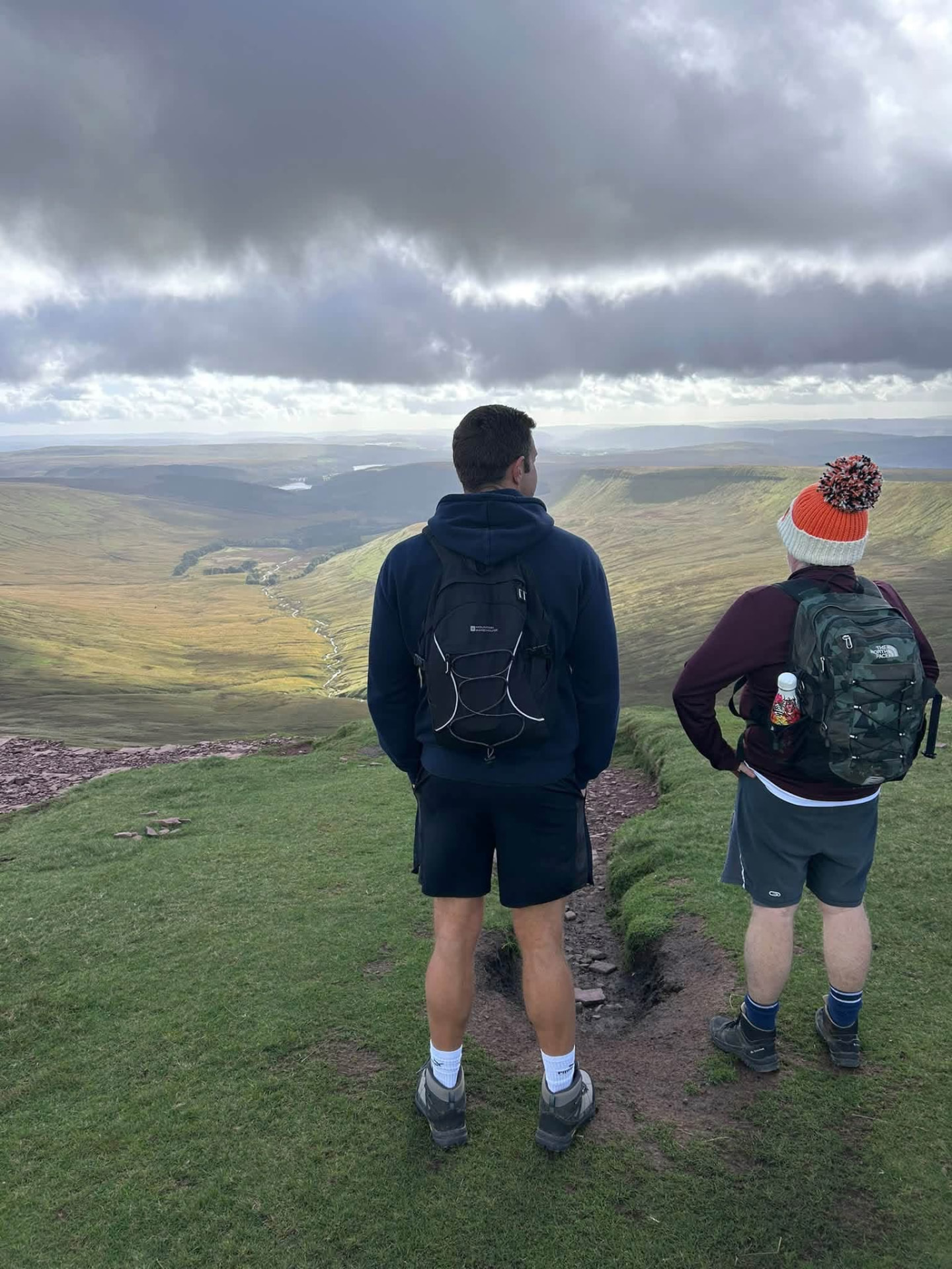 Two members looking out over the valley from the high ground